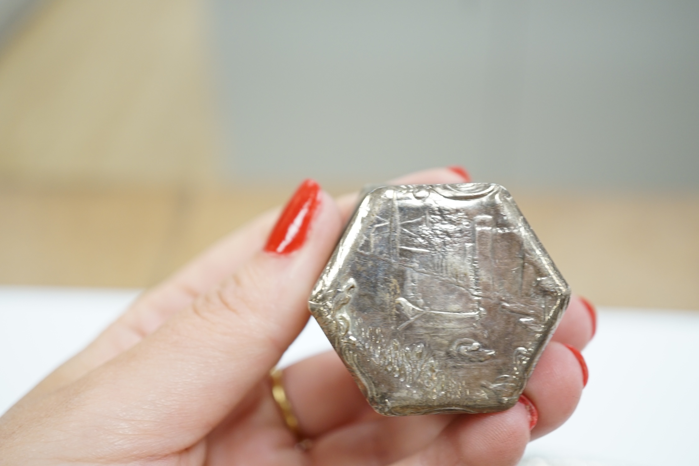 Six assorted early 20th century and later repousse silver boxes, largest 75mm and one similar white metal box.